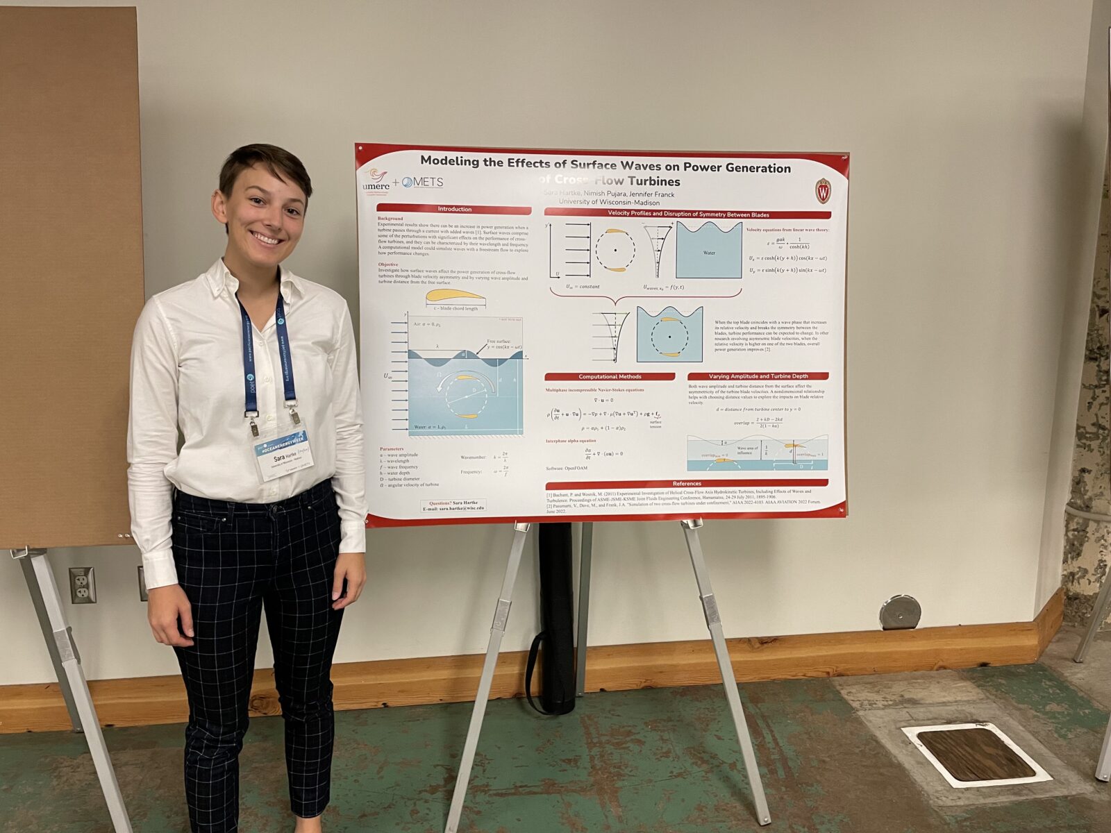 phd students presenting a conference poster